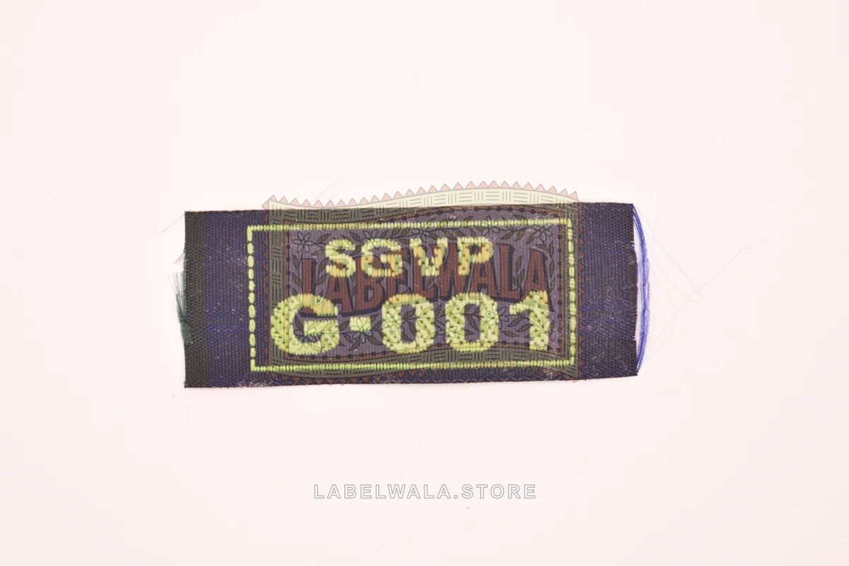 SGVPGGreen woven end fold label, made in Ahmedabad: front view