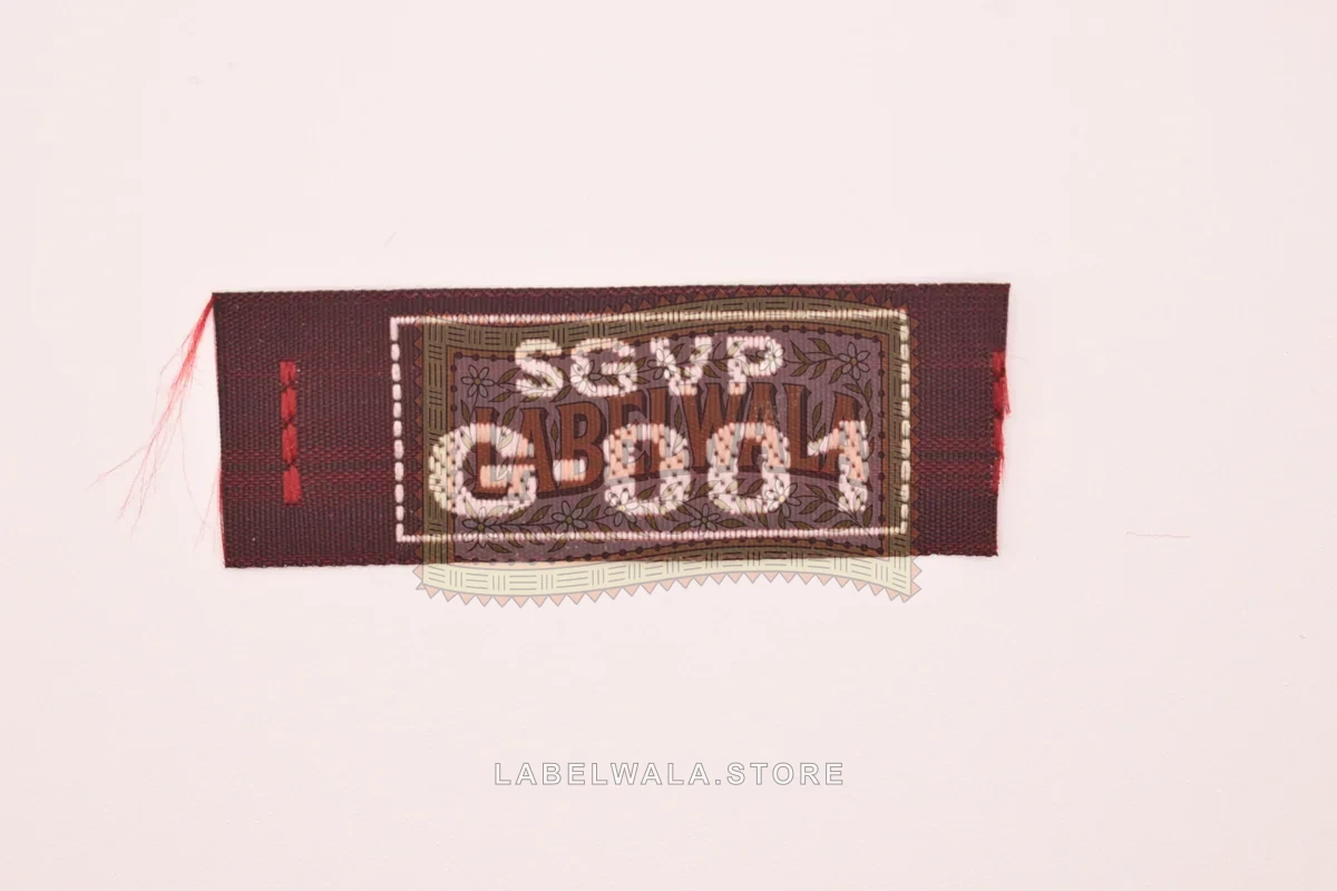 SGVPGMaroon woven end fold label, made in Ahmedabad: front view