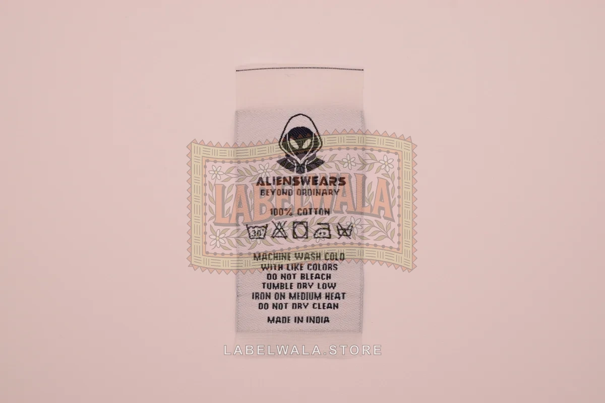 Aliance Care woven center fold label, made in Ahmedabad: front view
