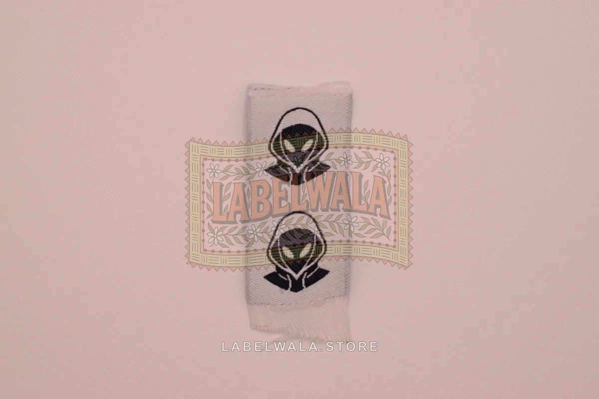 Aliensicon woven center fold label, made in Ahmedabad: front view