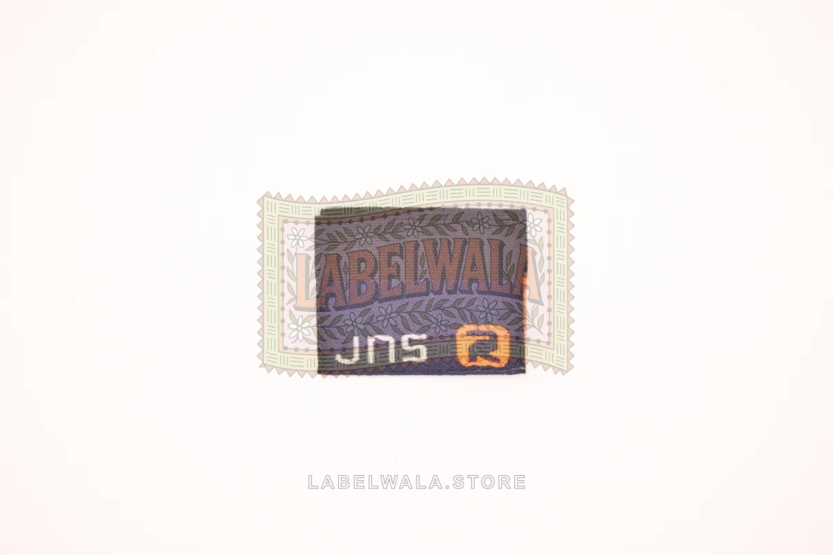 JSN woven center fold label, made in Ahmedabad: front view