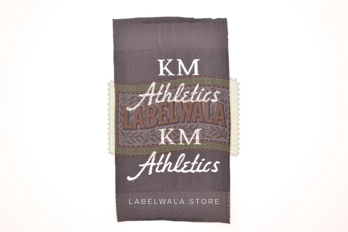 KM woven center fold label, made in Ahmedabad: front view