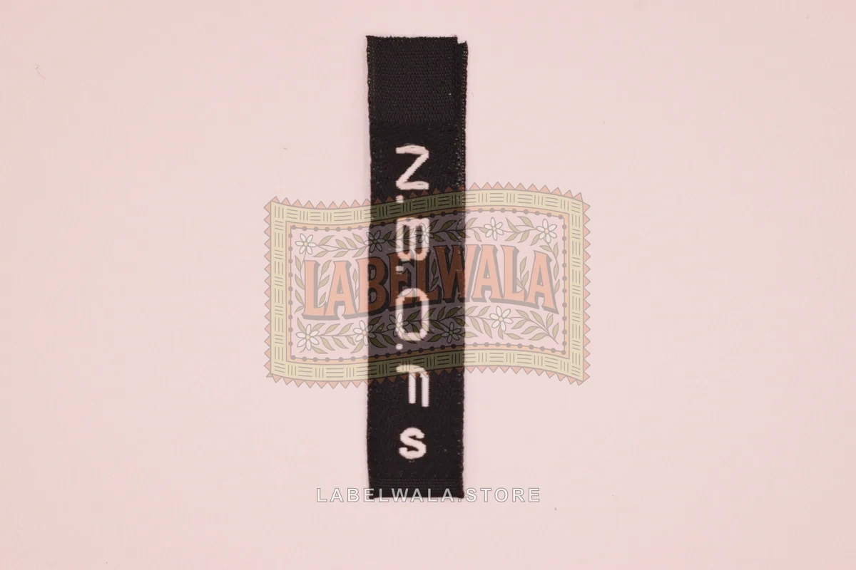 NROS woven center fold label, made in Ahmedabad: front view
