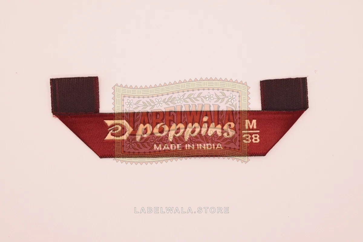 Poppinss woven hanger loop label, made in Ahmedabad: front view