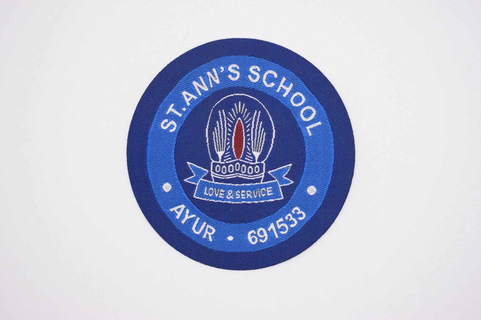 Stann's School die-cut woven uniform label: front view, school uniform label sample