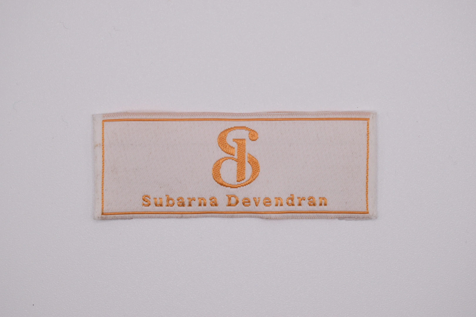 Subarna end-fold woven brand label: front view, custom clothing label sample