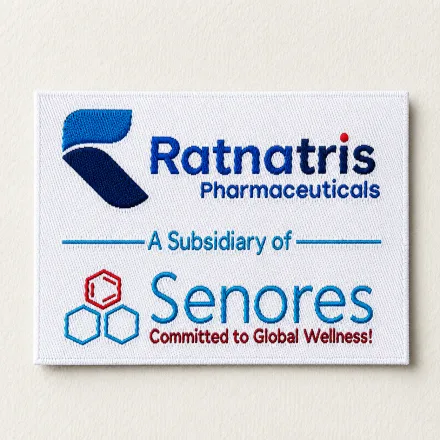 Ratnatris Pharmaceuticals white woven brand label with full-colour logo, Senores subsidiary credit and Committed to Global Wellness tagline, corporate uniform woven label sample