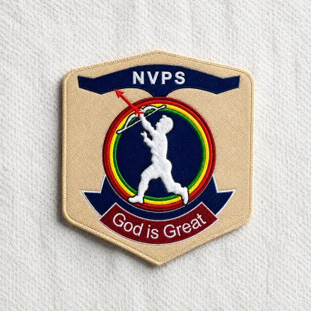 NVPS cream embroidered shield patch with batsman silhouette, multi-colour rings and God is Great banner: sports and school crest embroidered patch sample