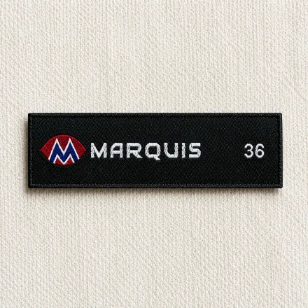Marquis black woven brand label with red-and-white M logo, white wordmark and size 36 marker, menswear brand woven label sample