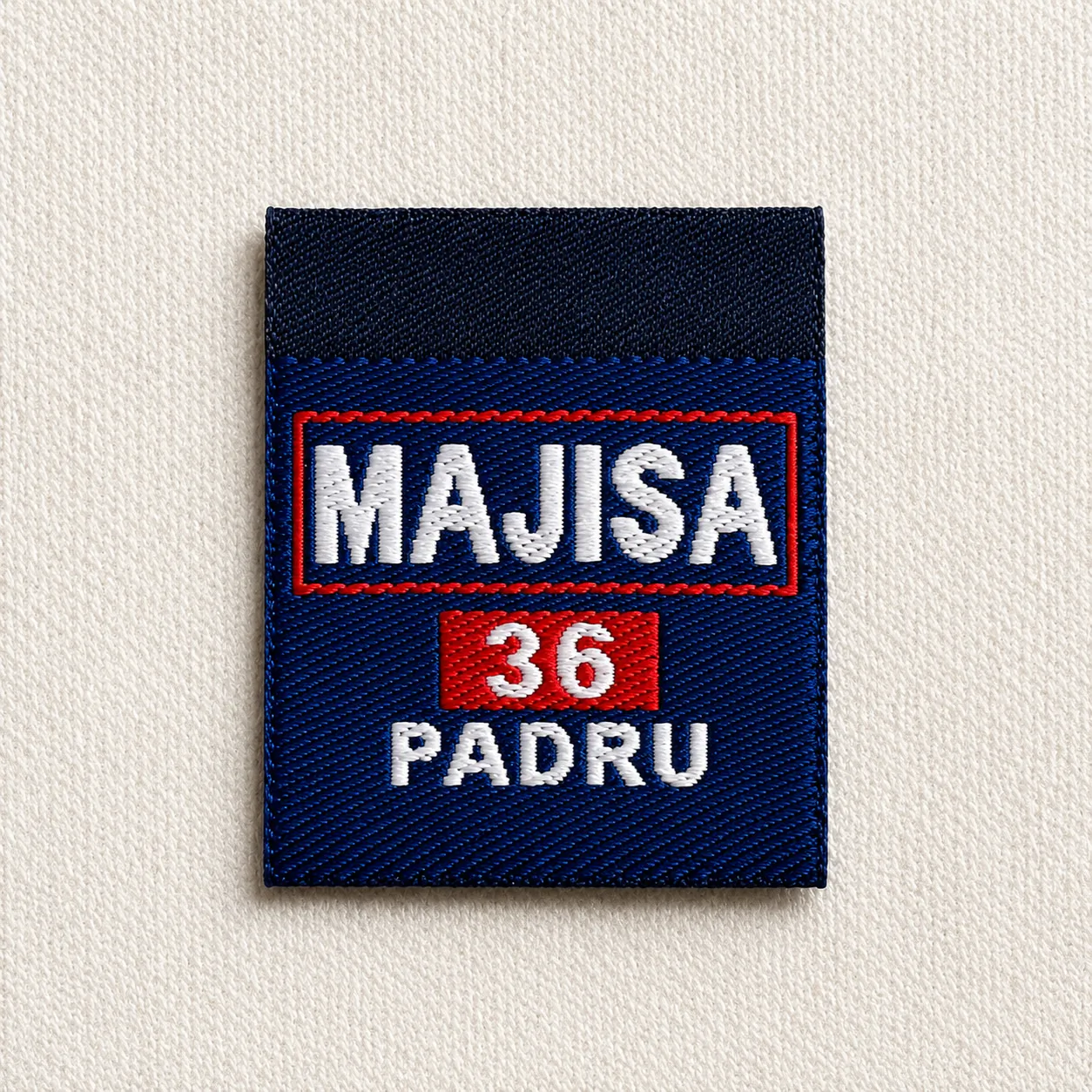 Majisa Padru navy-and-red woven name and number label with white wordmark and size 36 — uniform identification woven label sample
